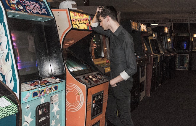 someone playing on an arcade machine
