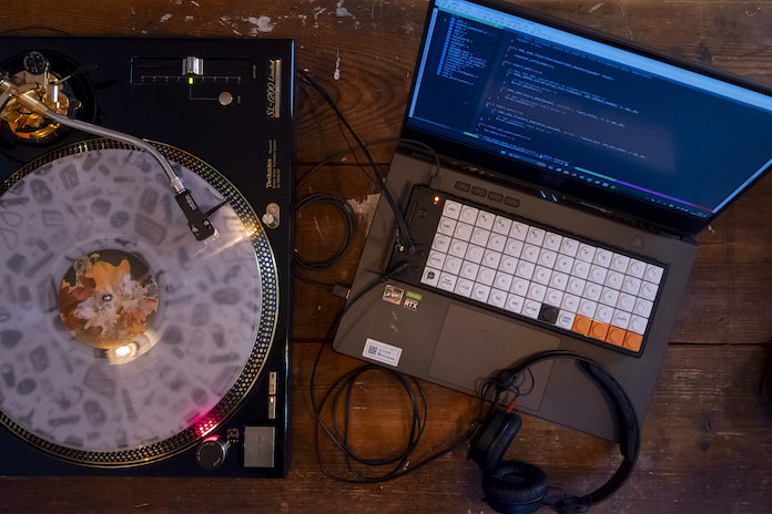 The C4NDY KeyVLM, a keyboard device, on top of a laptop and next to a turntable